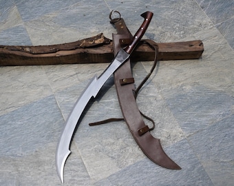 May include: A curved, silver-bladed sword with a dark wooden handle and a brown leather sheath. The blade has a unique, serrated edge. The handle is dark brown with lighter wood accents. The sheath is secured with leather straps.