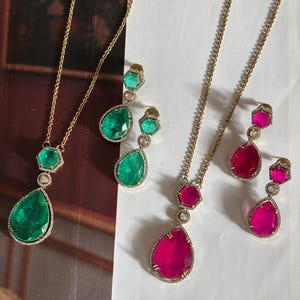 May include: A trio of ceramic mugs with a speckled, matte finish in cream, light grey, and dark grey. Each mug features a minimalist design and a rounded handle. Suitable for tea or coffee. Measurements are not visible.