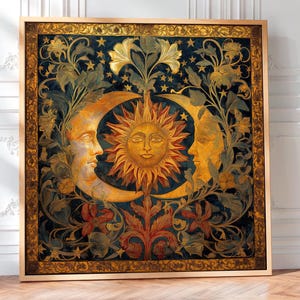 May include: A square framed wall art piece featuring a central golden sun with a human face surrounded by two crescent moons, also with human faces, set against a dark blue background with intricate gold floral vines and small stars.
