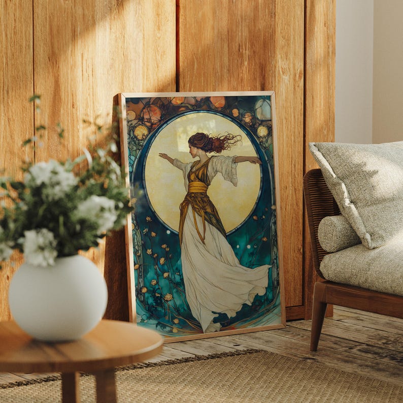 May include: A rectangular framed art print featuring a stylized illustration of a person with flowing hair and a long, layered dress in shades of white and gold. The figure is centered against a large, glowing yellow moon, surrounded by dark teal foliage.
