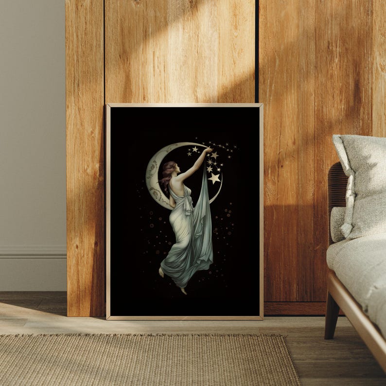 May include: A framed rectangular wall art print featuring a black background with a central illustration of a figure in a flowing light-colored gown reaching toward a crescent moon and a cluster of golden stars, surrounded by small floating light orbs.