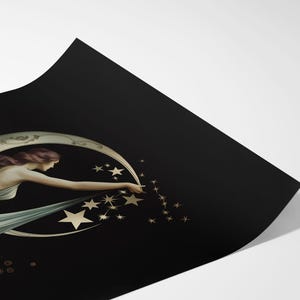 May include: A rectangular art print on black paper featuring a figure in a flowing white gown reaching toward a crescent moon. The figure is surrounded by gold-toned stars and circular patterns, with the print corner curled upward to show depth.