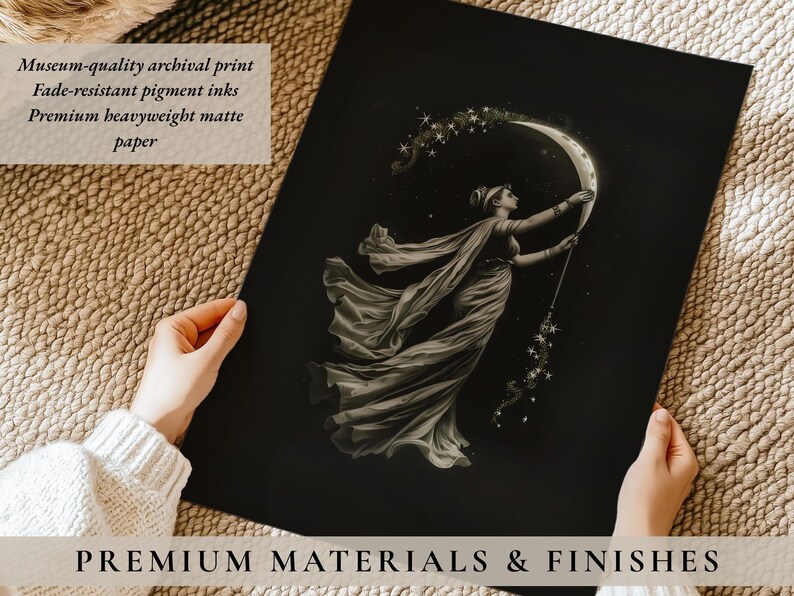 May include: A black and white print featuring a woman in a flowing gown holding a crescent moon and a star-filled wand. The print is on matte paper and includes the text "PREMIUM MATERIALS & FINISHES".