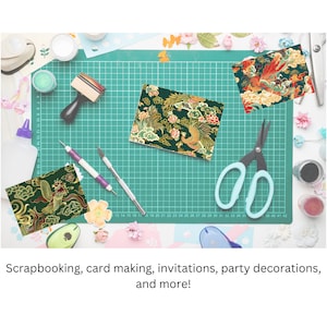 May include: A green cutting mat with a grid pattern, surrounded by craft supplies, including scissors, a stamp, and patterned paper with a phoenix design. The text "Scrapbooking, card making, invitations, party decorations, and more!" is visible at the bottom of the image.