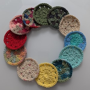May include: A collection of 12 crocheted round coasters in various colors and patterns, including green, blue, yellow, red, and pink.