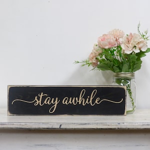 lightly distressed stay awhile wood sign