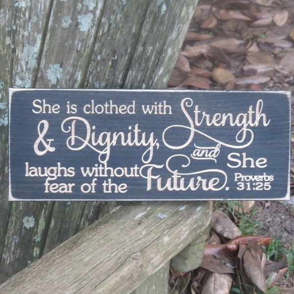 She is clothed with strength and dignity and laughs without fear of the future lightly distressed wood sign