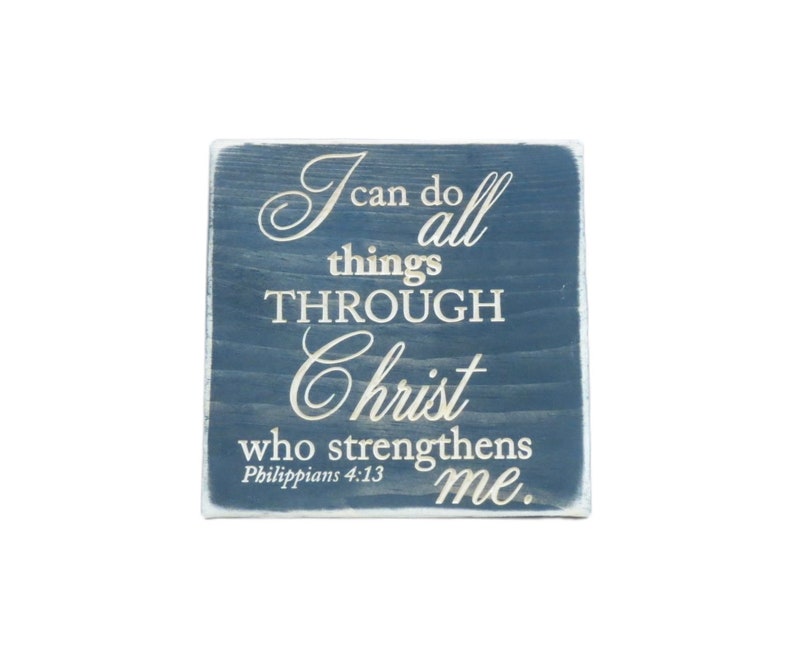 May include: A blue wooden sign with white lettering that reads "I can do all things THROUGH Christ who strengthens me. Philippians 4:13"
