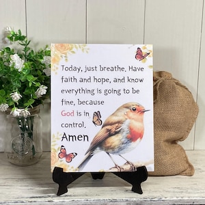 May include: A white sign with a robin and butterflies, with the text "Today, just breathe. Have faith and hope, and know everything is going to be fine, because God is in control. Amen."