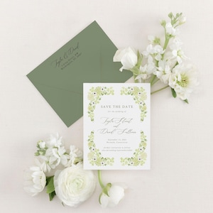 May include: Save the date card with a floral border in shades of green and white. The text reads "Save the Date for the wedding of Tayler Strait and Drew Sallins, September 13, 2023, Norwalk, Connecticut. Formal invitation to follow. www.wedding.com/username/wedding"