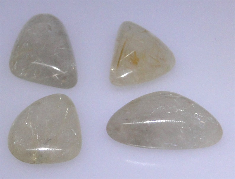 various shapes and sizes Four gold rutilated Quartz cabochons 64.12 carats total WHGC-0082