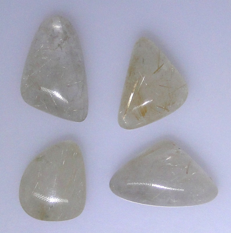 various shapes and sizes Four gold rutilated Quartz cabochons 64.12 carats total WHGC-0082