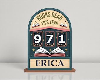 May include: A wooden book counter with the text "BOOKS READ THIS YEAR" at the top. The counter displays the number "971" and the name "ERICA" at the bottom. The design includes open book illustrations and star accents.