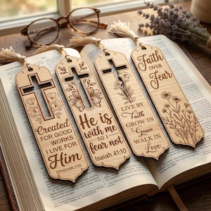 May include: Four wooden bookmarks with tassel ends rest on an open book. Each bookmark features a cross design and inspirational text, including "Faith Over Fear" and Bible verses. The bookmarks are light brown with intricate laser-cut details.