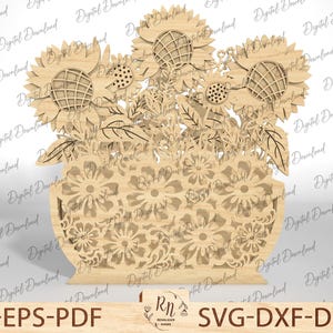 May include: A laser cut wooden napkin holder featuring a bouquet of sunflowers and smaller flowers in a vase. The design is intricate and detailed, with delicate leaves and petals.
