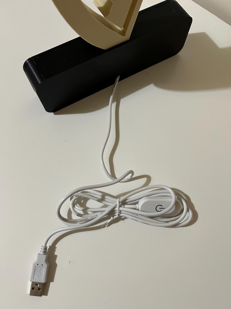 May include: A white USB cable with a power switch and a USB connector. The cable is coiled and the switch has a power symbol.