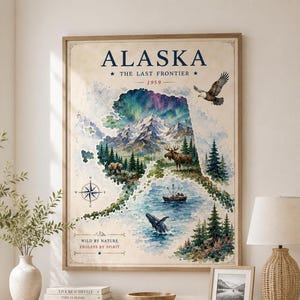 May include: A framed wall art print featuring a watercolor map of Alaska. The design includes the text ALASKA, THE LAST FRONTIER, 1959, WILD BY NATURE, and ENDLESS BY SPIRIT. Illustrations depict mountains, a moose, a bear, a whale, and an eagle.