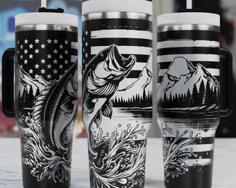 May include: Three black and white stainless steel tumblers with lids and straws. The tumblers feature a graphic design of a bass fish jumping out of the water with a mountain and American flag background.