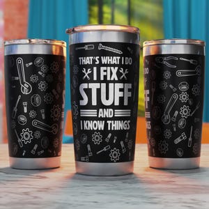 May include: Three stainless steel tumblers with black and white designs. The center tumbler has the text "That's what I do I fix stuff and I know things".