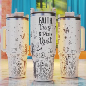 May include: Three white stainless steel tumblers with black handles and lids. The center tumbler has the text "FAITH trust & Pixie Dust" printed on it. All three tumblers have a black and white fairy and flower design.