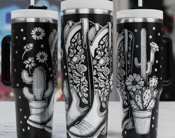 May include: Three black insulated tumblers with white lids and straws. Each tumbler features a different white graphic: cowboy boots, cacti, and floral designs. The tumblers have black handles and are decorated with stars.