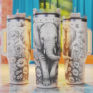 May include: White stainless steel tumbler featuring a black and white illustration of an elephant walking through a field of daisies. The tumbler has a lid and a handle.