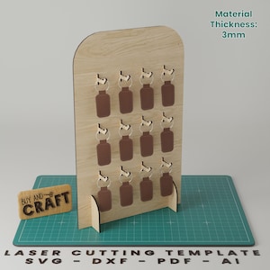 Puede incluir: Un soporte de llaves de madera con 12 ganchos para llaves. El soporte está hecho de madera de 3 mm de grosor y está diseñado para corte por láser. La imagen incluye el texto "BUY AND CRAFT" y "LASER CUTTING TEMPLATE SVG - DXF - PDF - AI".