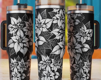May include: Three black stainless steel tumblers with a white poinsettia floral pattern. The tumblers have lids and straws.