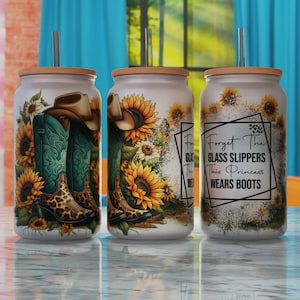 May include: Three white tumblers with lids and straws. The tumblers feature a design of cowboy boots, sunflowers, and the text "Forget the glass slippers, this princess wears boots".