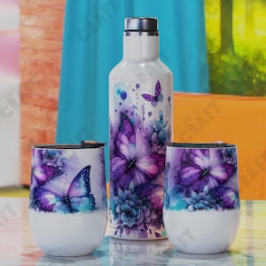 May include: A white water bottle and two stemless wine tumblers featuring a butterfly design. The butterflies are purple and blue with floral accents. The items are on a light-coloured surface.