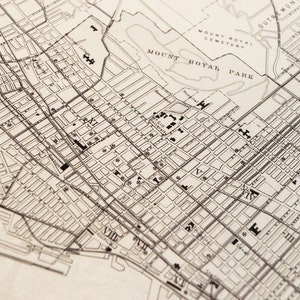 May include: A black and white map of a city showing street names and numbers. The map depicts the area around Mount Royal Park in Montreal, Canada.