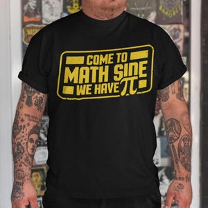 May include: Black t-shirt with a yellow rectangle graphic that says "Come to Math Side We Have Pi".