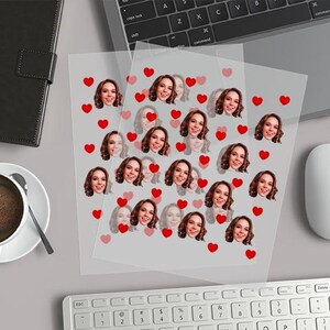a computer keyboard, mouse, mouse pad, and photo of a woman's