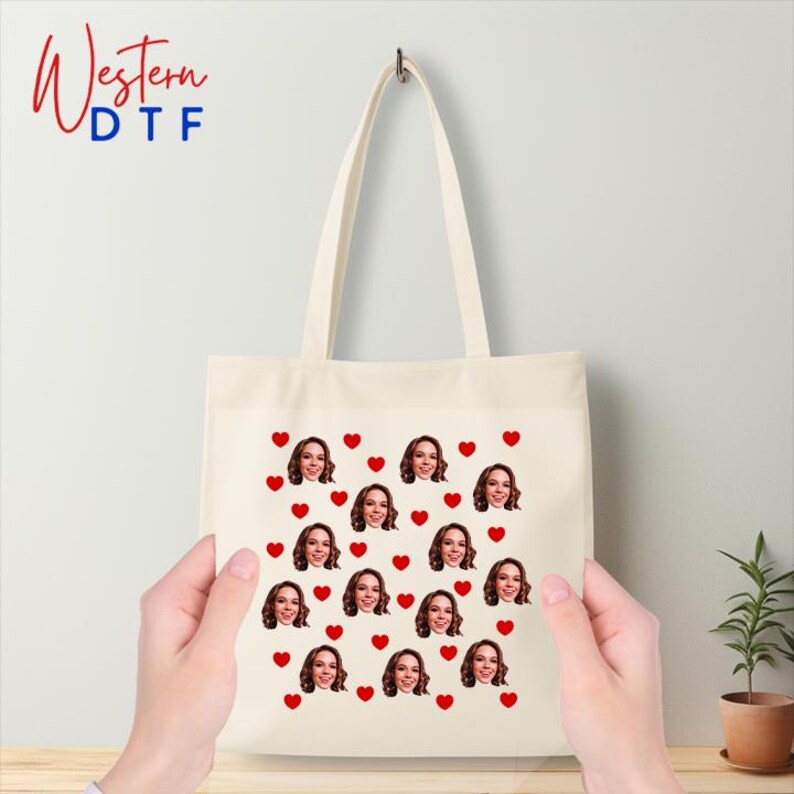 a person holding a tote bag with a picture of a woman's face