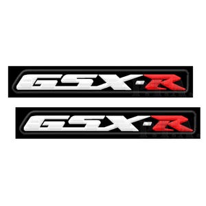 May include: Two embroidered patches featuring the text "GSX-R" in white, with a red "R" at the end. The patches are outlined in black and are likely for motorcycle apparel or accessories.