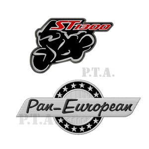 May include: Two embroidered patches. The top patch features a black motorcycle silhouette with the text "ST1300" in red. The bottom patch reads "Pan-European" in a silver banner with a star-studded circle.