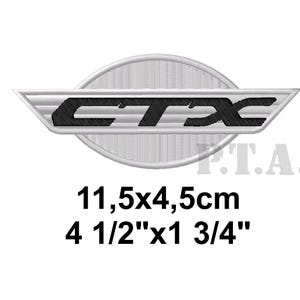 May include: Embroidered patch featuring the word "CTX" in black, set against a white, oval-shaped background with a textured design. The patch measures 4 1/2" x 1 3/4".