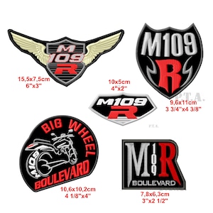 May include: Embroidered patches with motorcycle-themed designs. Includes patches with the text "M109", "Big Wheel Boulevard", and "Boulevard". The patches feature black, red, and white colors. Sizes range from 3"x2 1/2" to 6"x3".