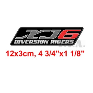 May include: Black and red rectangular patch with the text "XJ6 DIVERSION RIDERS". The patch measures 4 3/4" x 1 1/8" (12x3cm). The text is in white and red, with a black background.