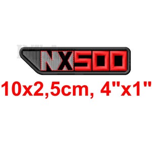 May include: Embroidered patch with the text "NX500" in red and black. The patch is rectangular, with dimensions of 4" x 1" (10cm x 2.5cm). The patch has a black border and is on a white background.
