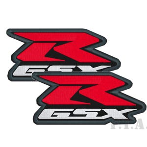 May include: Two embroidered patches featuring a red and white GSX logo with a black border. The GSX logo is a stylized design, with the letters stacked on top of each other. The patches are likely for motorcycle enthusiasts.