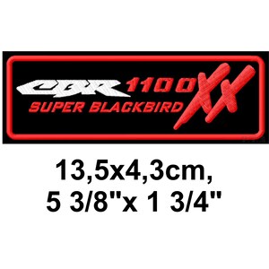 May include: Black embroidered patch with the text "CBR 1100 SUPER BLACKBIRD" in white and red. The patch is rectangular with a red border and two red "X" shapes. The patch measures 5 3/8" x 1 3/4".