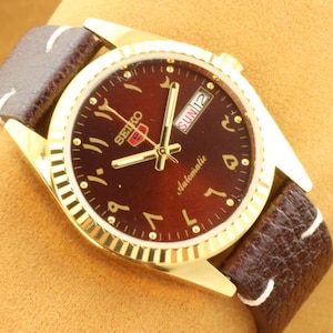 1980s Vintage refurbished automatic Seiko 5 arabic elegant  brown dial golden men&#39;s working wrist watch 35mm.. authentic and iconic