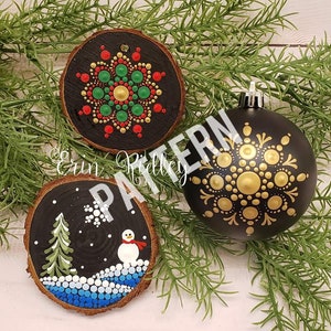 May include: Three Christmas ornaments painted with dot art designs. The first ornament is a round wooden slice with a red, green, and gold mandala design. The second ornament is a round wooden slice with a winter scene of a snowman, a pine tree, and snowflakes. The third ornament is a round glass ornament with a gold mandala design.