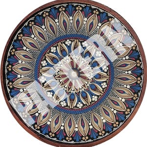 May include: Round wooden tray with a detailed, colorful mandala design. The mandala features a symmetrical pattern with blue, beige, and red accents, encased in a dark brown wooden frame. The design is covered with a clear glass surface.