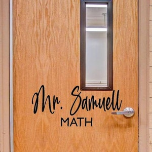 May include: A wooden door with a glass window pane and a black sign that reads "Mr. Samuel MATH".