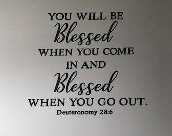 May include: Black and white text on a white wall that reads "You will be Blessed when you come in and Blessed when you go out. Deuteronomy 28:6"