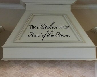May include: White kitchen range hood with a black vinyl decal that reads "The Kitchen is the Heart of this Home."