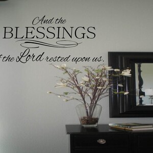 May include: A black and white wall decal with the text "And the BLESSINGS of the Lord rested upon us."