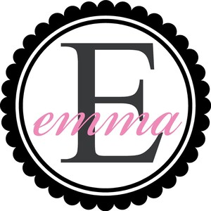 May include: A black and white circular frame with a scalloped edge. The letter "E" is in the center in black, with the name "emma" written in pink cursive below.